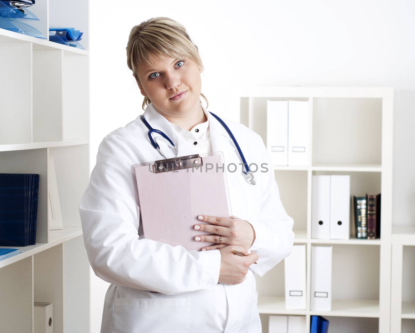 portrait of a young woman doctor with a clipboard, smiling