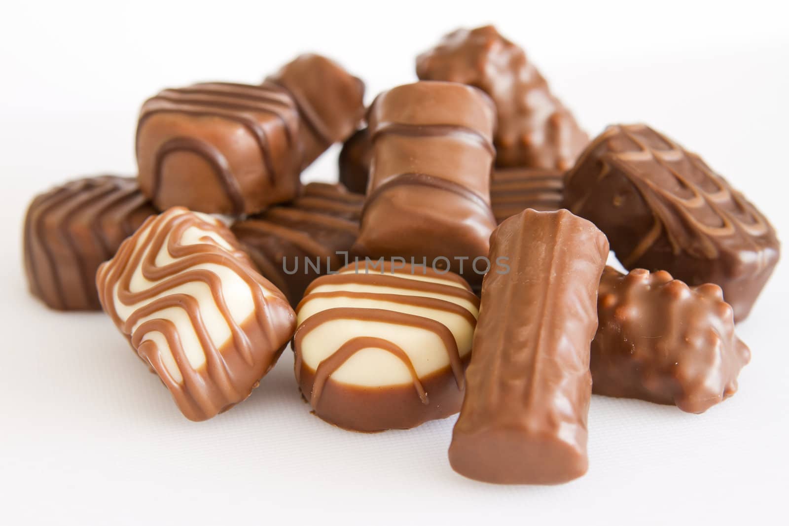 Lots of chocolate. White background. Close-up.