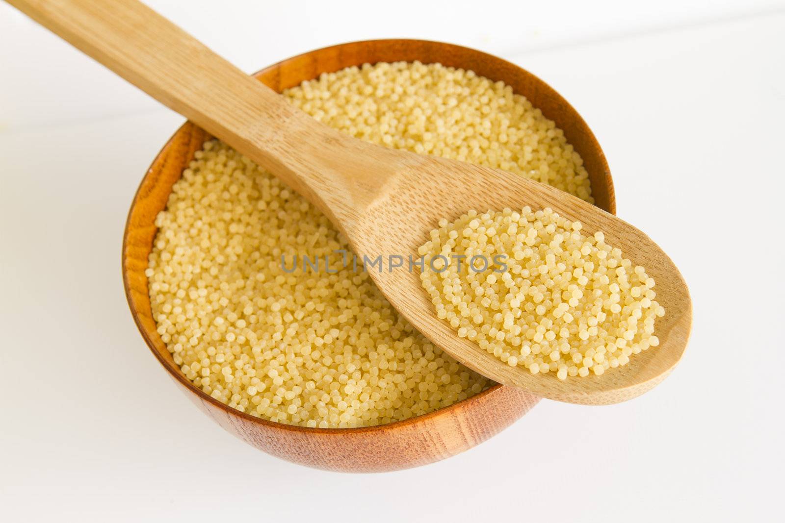  wooden spoon and bowl with Vermicelli pasta on a white background