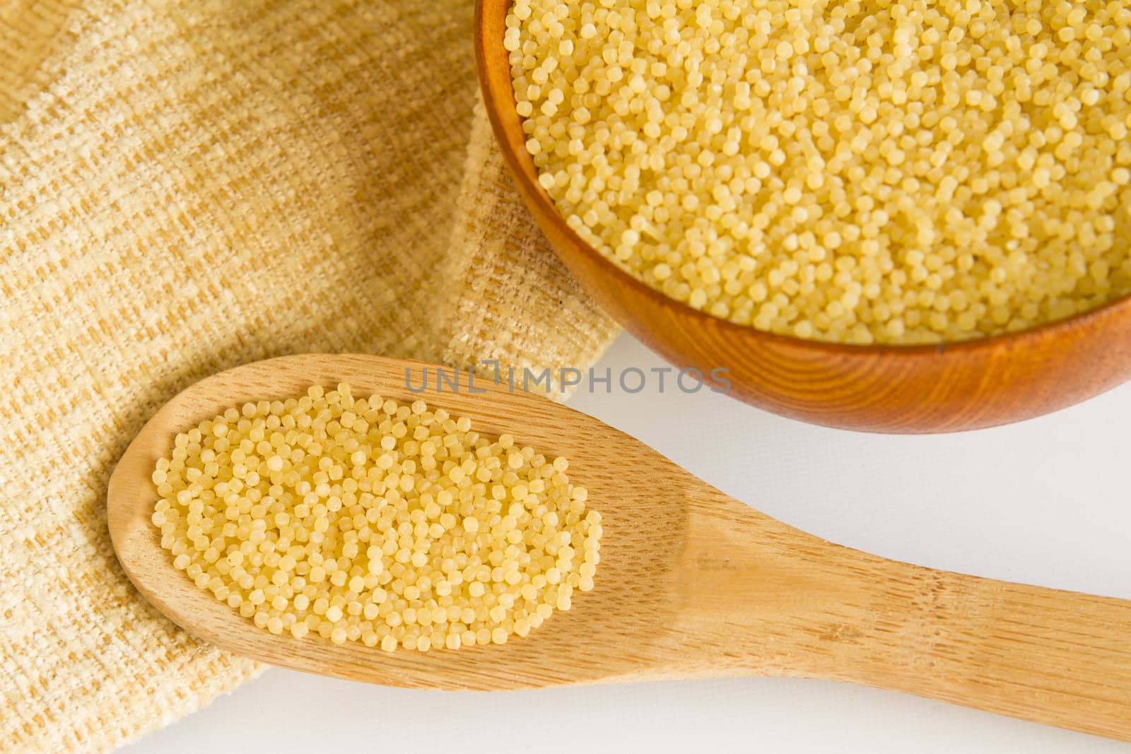  wooden spoon and bowl with Vermicelli pasta on a white background