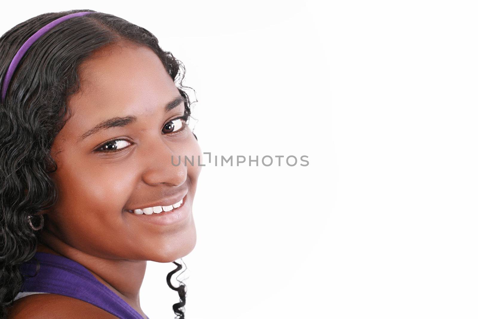 Beautiful smiling face of a happy African teenager girl, isolated.