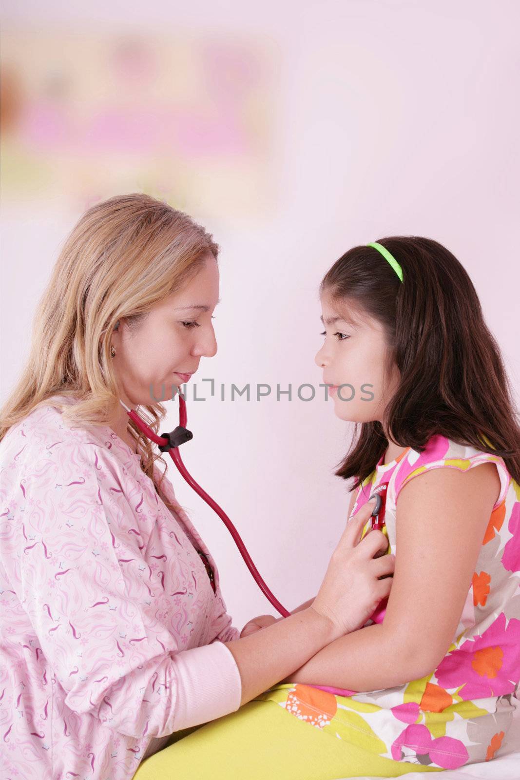 Female doctor examining little girl