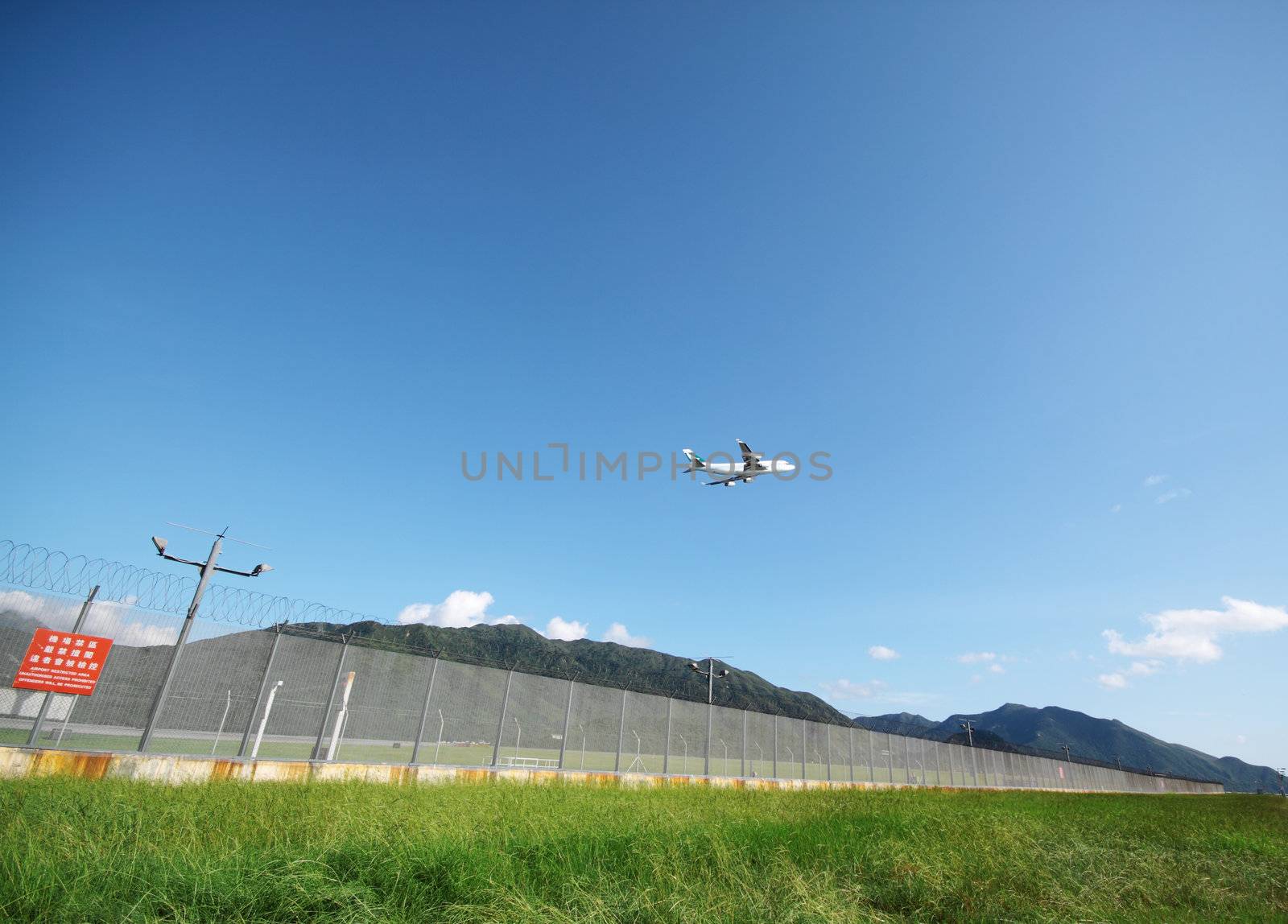 Airplane flying in green airport