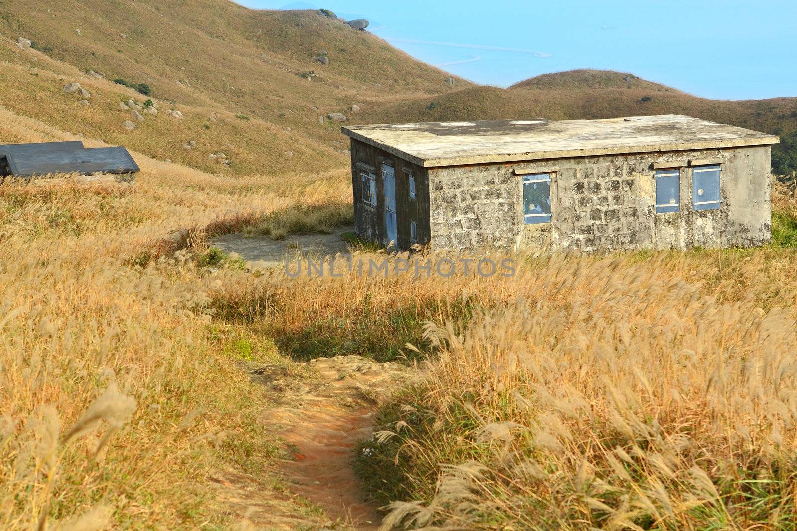 old stone house with grass on the mountain 