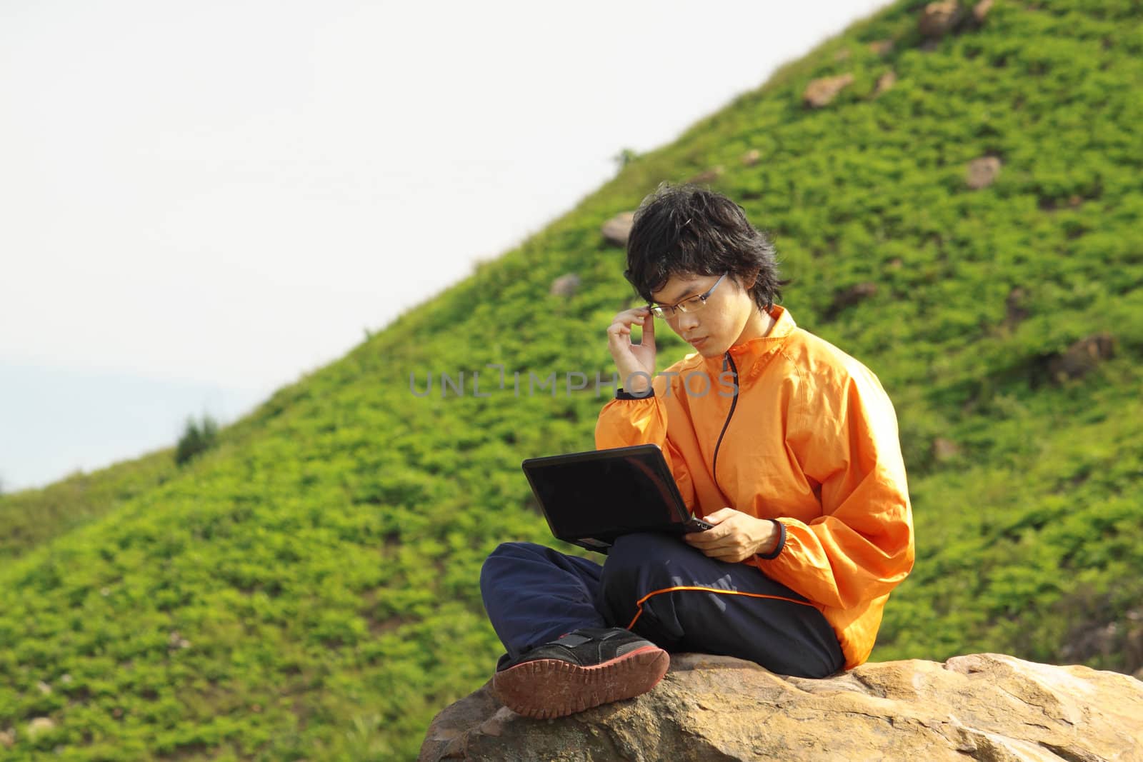 asain Man with notebook at day