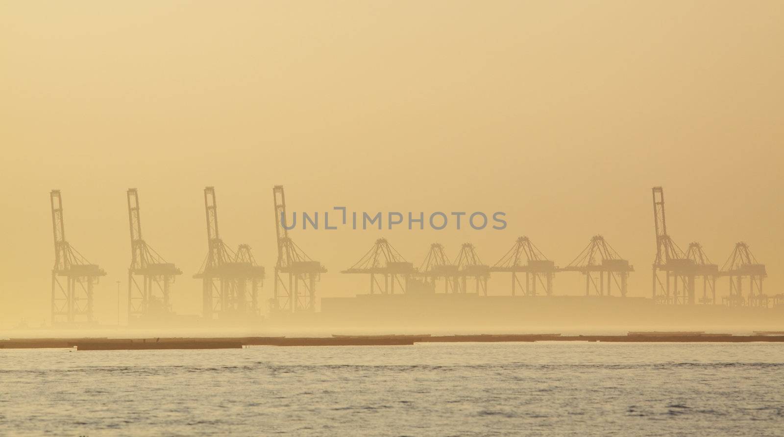 container cranes on a foggy morning