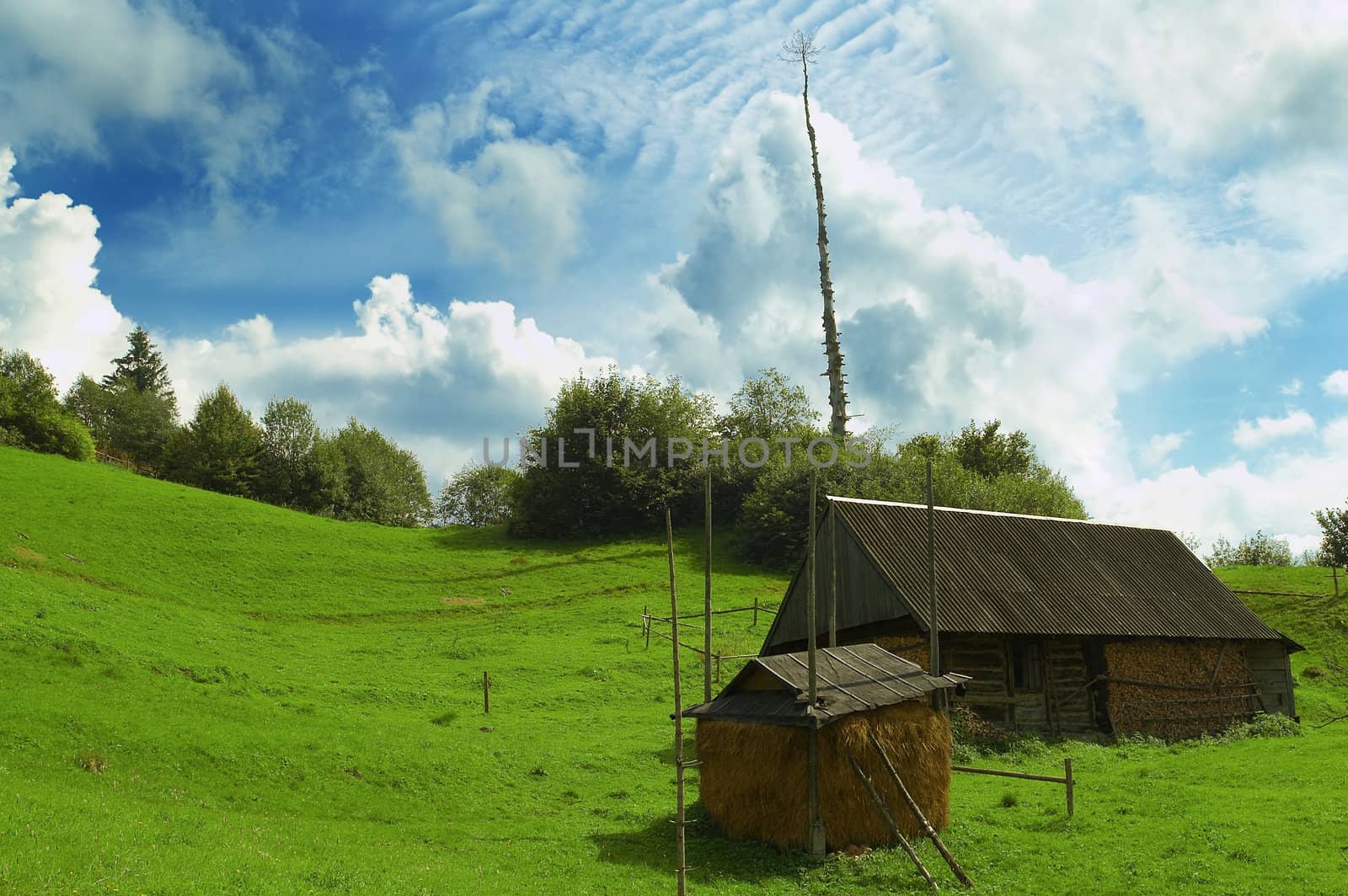 Rural house and stack under impressive clouds