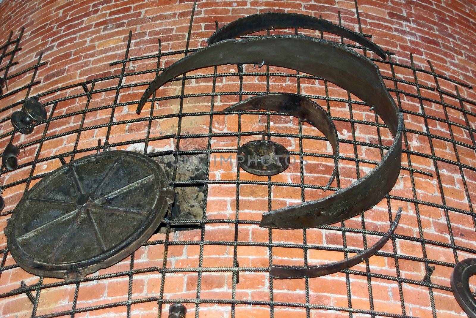 Decorative iron works on weathered brick wall