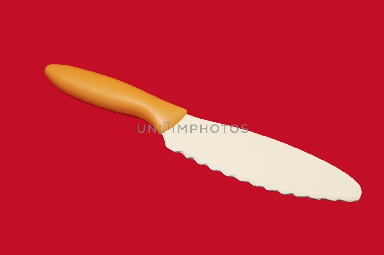 knife with a ceramic coating on a red background