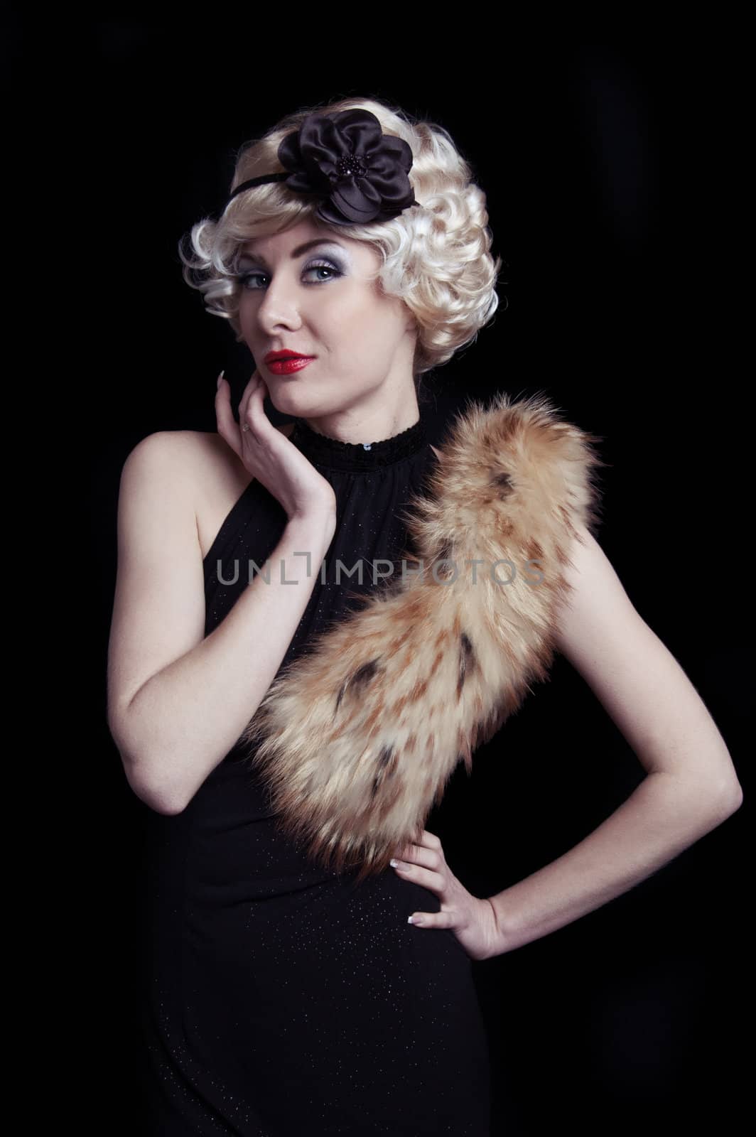Retro-styled woman with boa over black