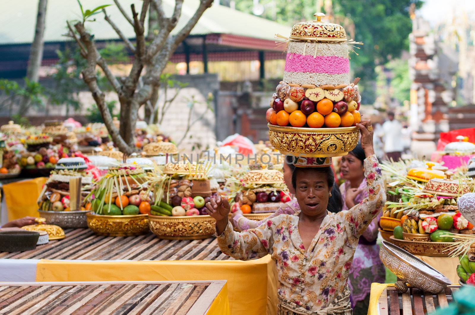 Tirta Empul, Bali, Indonesia - October 11, 2011: woman with basket on here head walking to Tirta Empul Temple to give offerings to the spirits