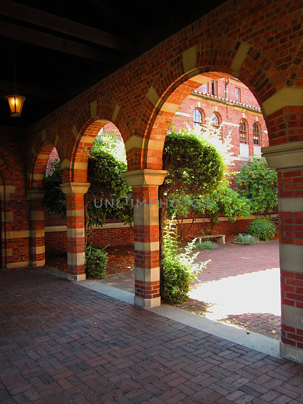 A photograph of an arched walkway of a church detailing its architectural design.