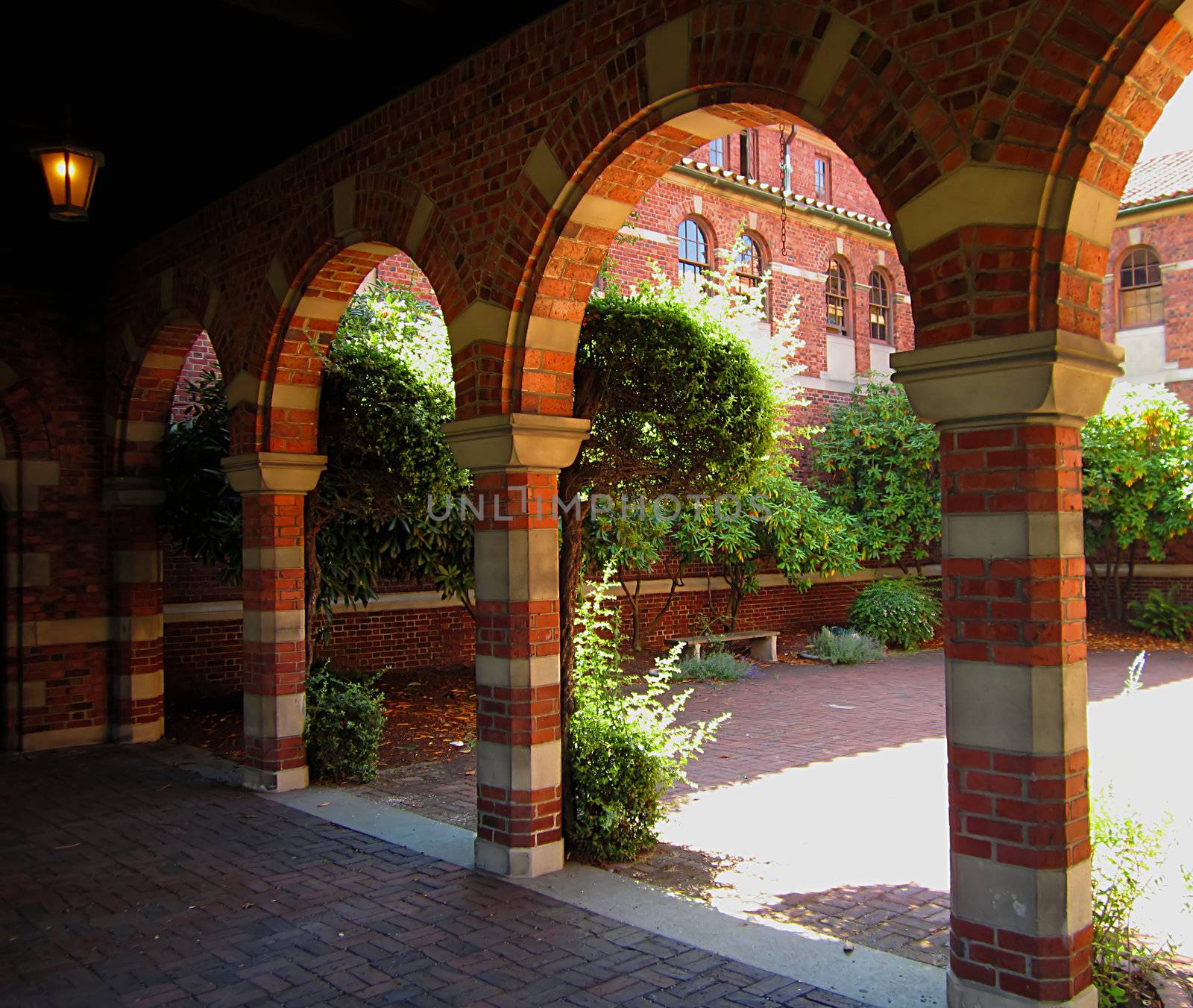 A photograph of an arched walkway of a church detailing its architectural design.