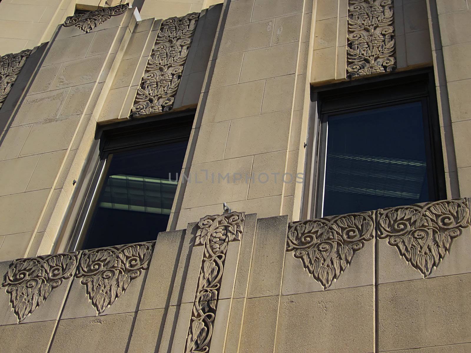 A photograph of a skyscraper detailing its architecture and window pattern.