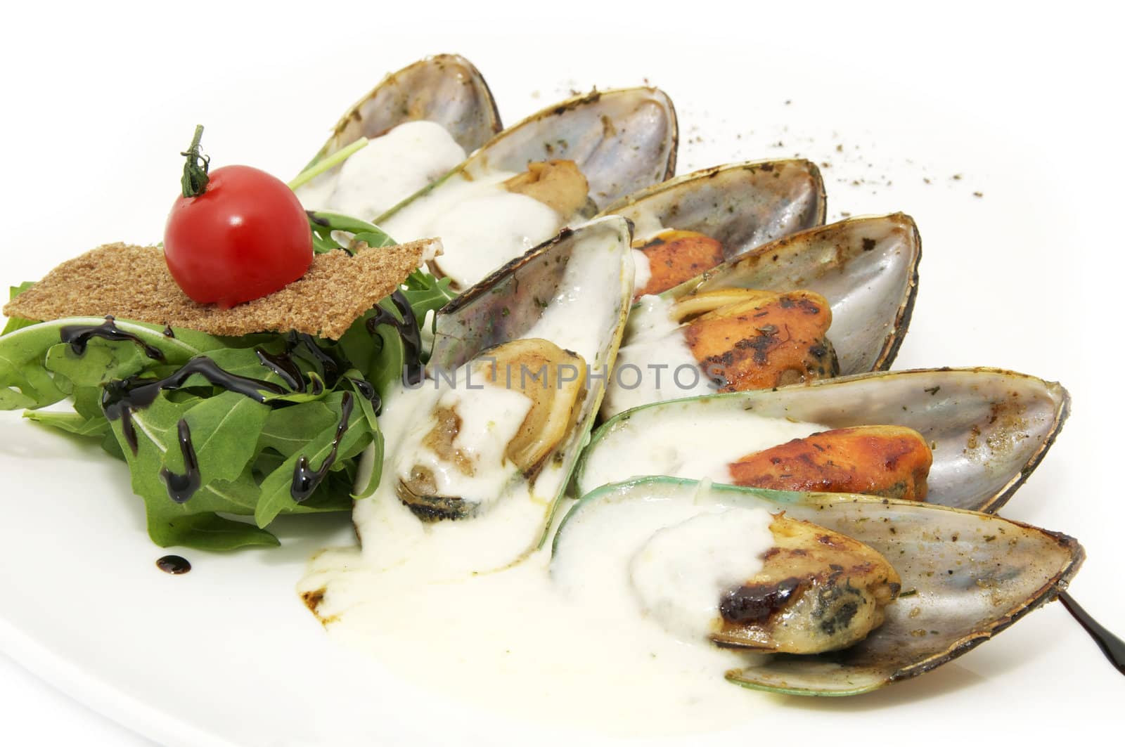 a plate of mussels and herbs in a restaurant