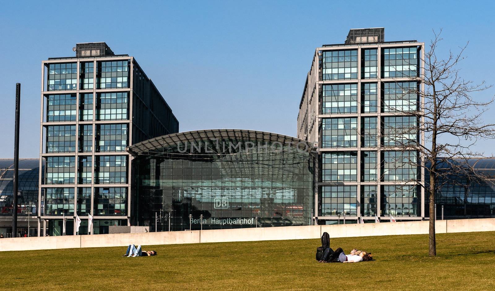 Berliners love to have a rest as soon as the sun peeps out. In the background, Berlins main station.