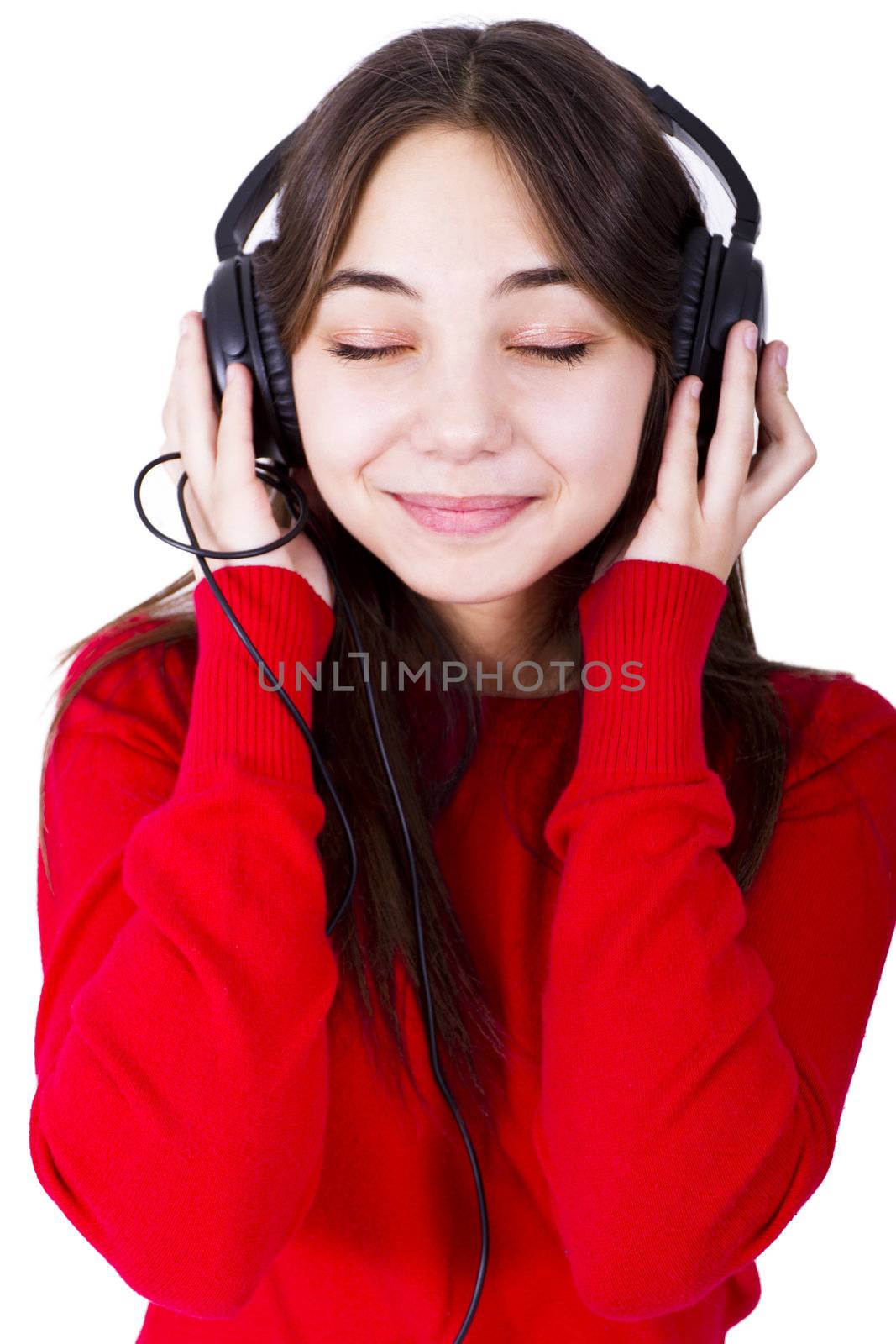 Young woman listening the music her eyes closed and looks like feeling the rhythm. Isolated on white background.