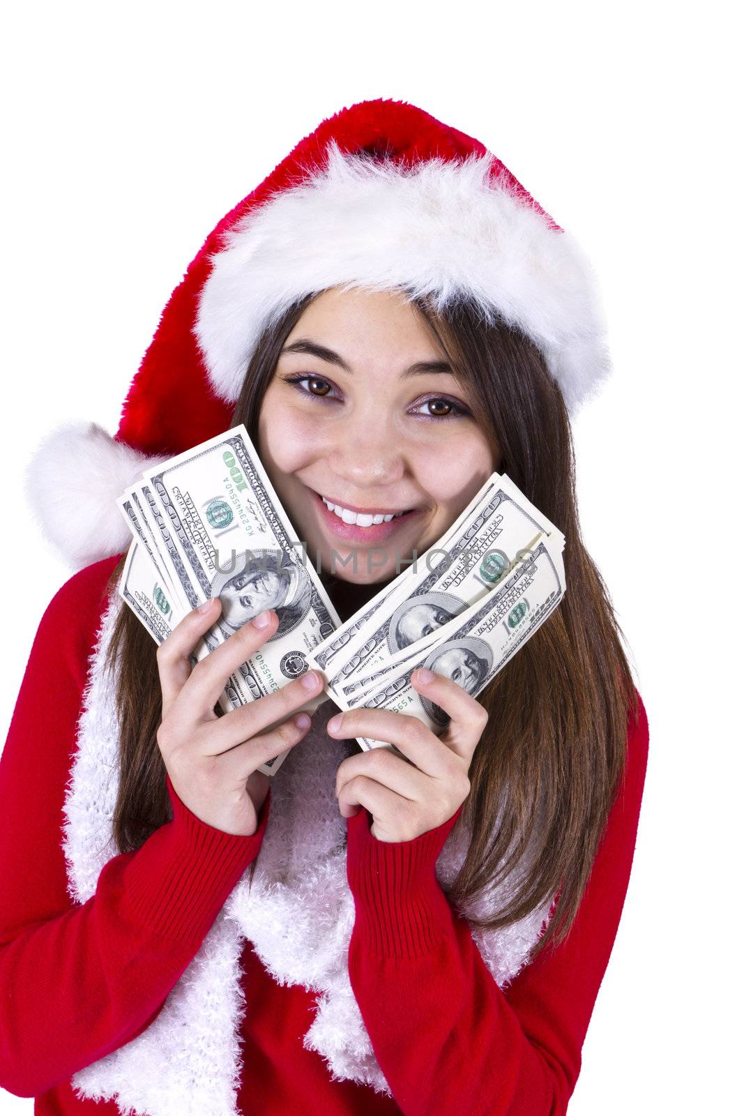 Santa Will Bring More Money. Teenager girl with Santas hat and holding her paycheck, all one hundred dollar banknotes. Isolated on white background.