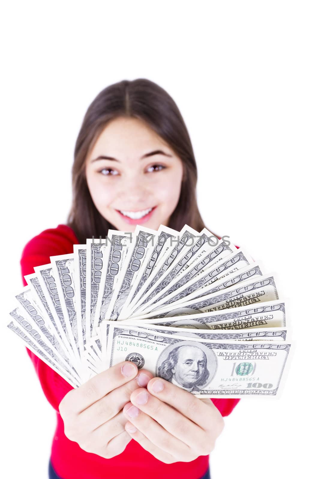 Young girl holding her paycheck, all one hundred dollar banknotes, asking what would you do with all this money, All one hundreds. Isolated on white background.