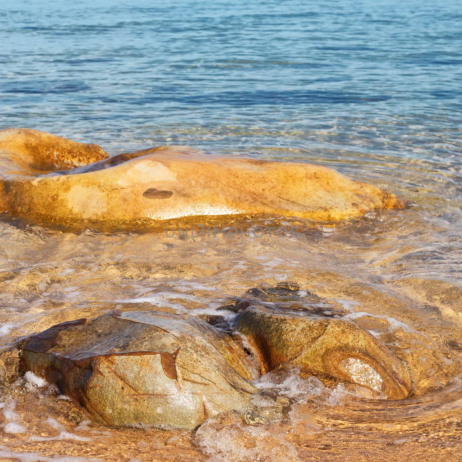 transparent sea with big stone at sunny day