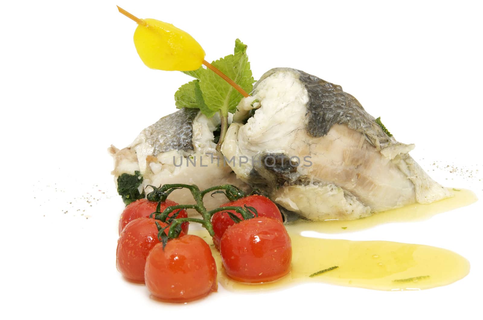 Baked fish fillets in the form of rolls with cherry tomatoes