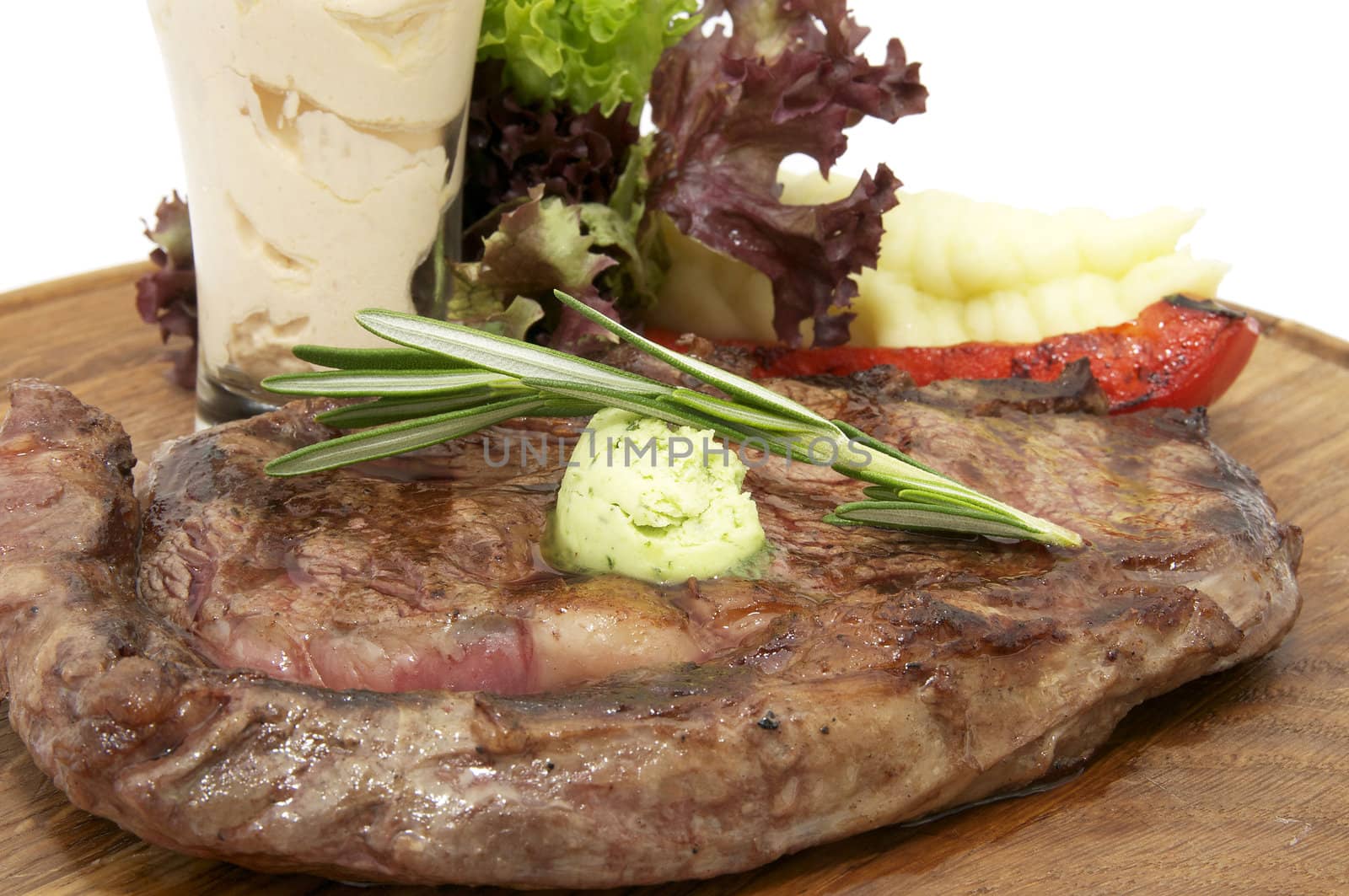 beef steak cooking on the grill with mashed potatoes