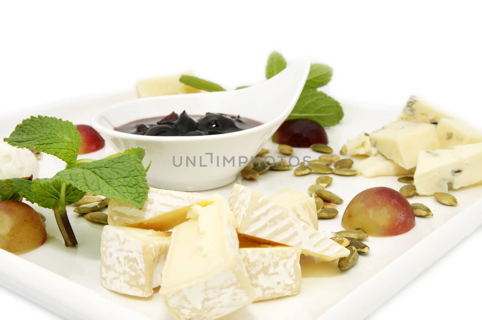 cheese plate with a large decorated the assortment of mint