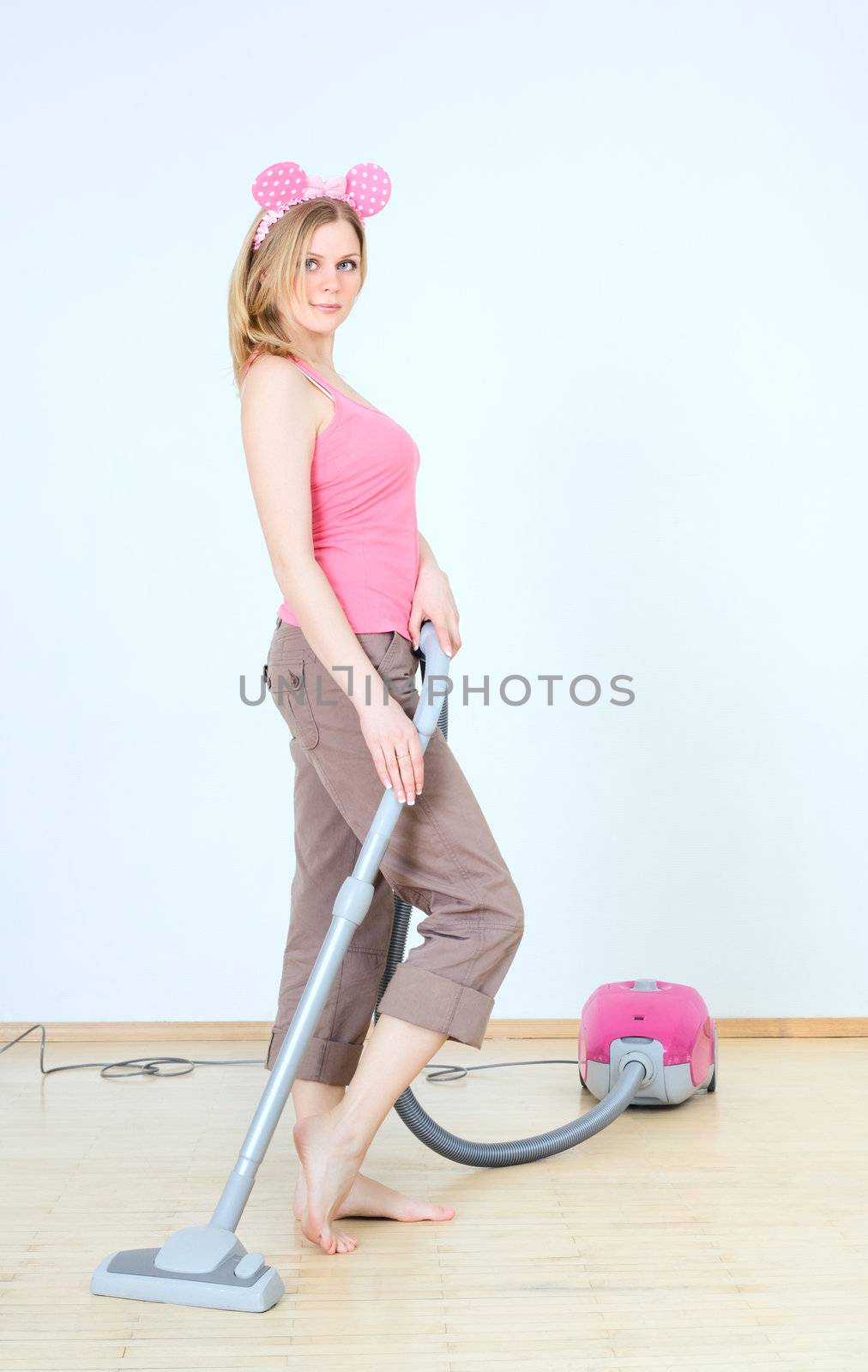cute young woman with vacuum cleaner at homework