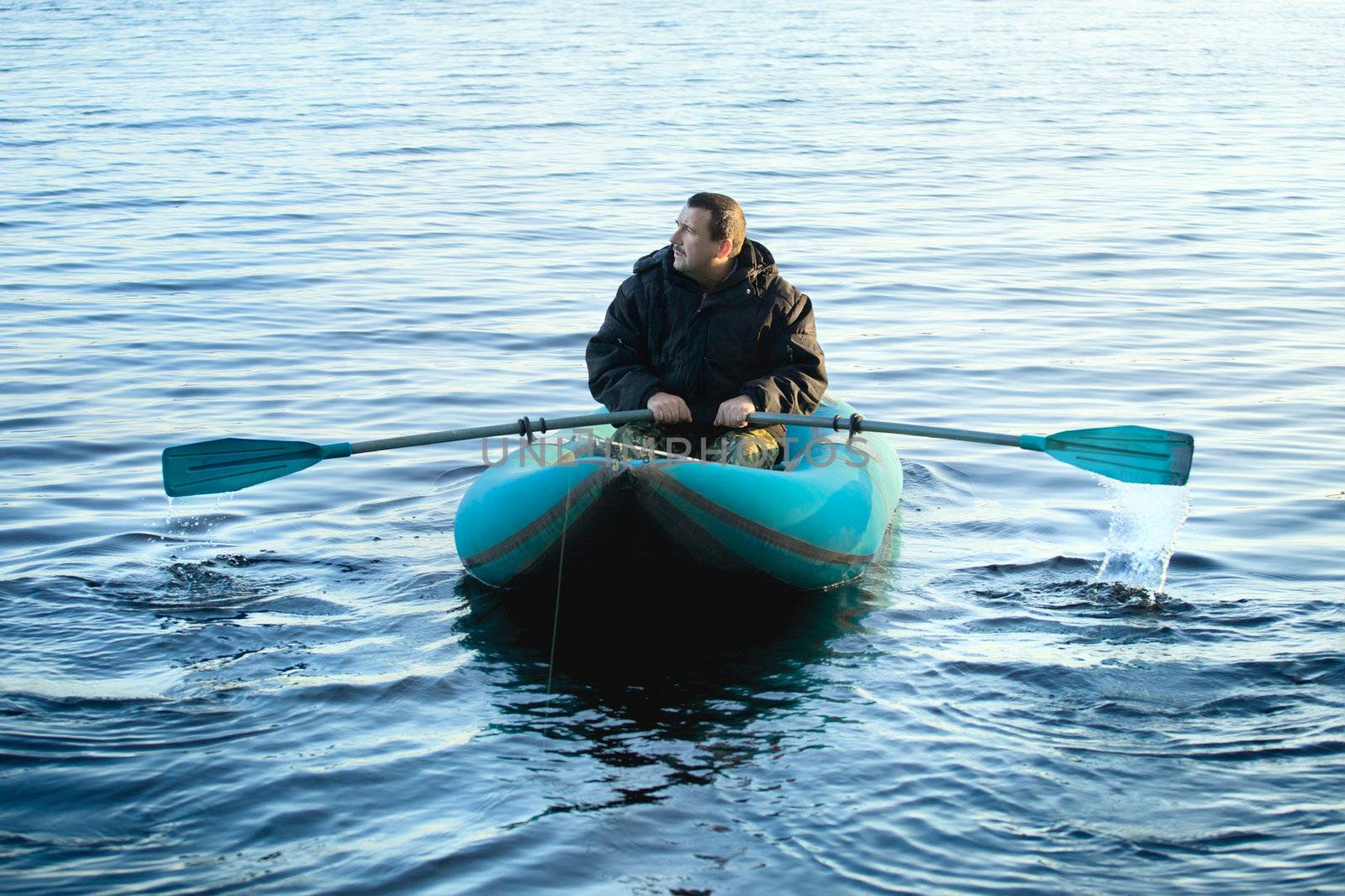 Fisherman in Rubber Boat by petr_malyshev