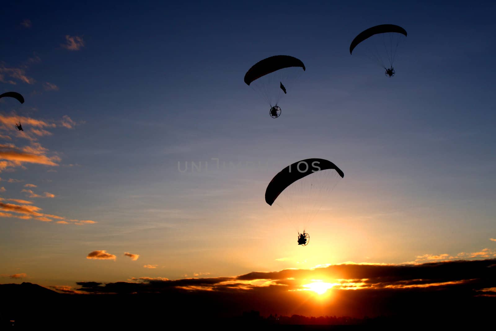 An early morning paragliding by the participants of the Annual Hot Air Balloon Fiesta in Angeles, Pampangga, Philippines.