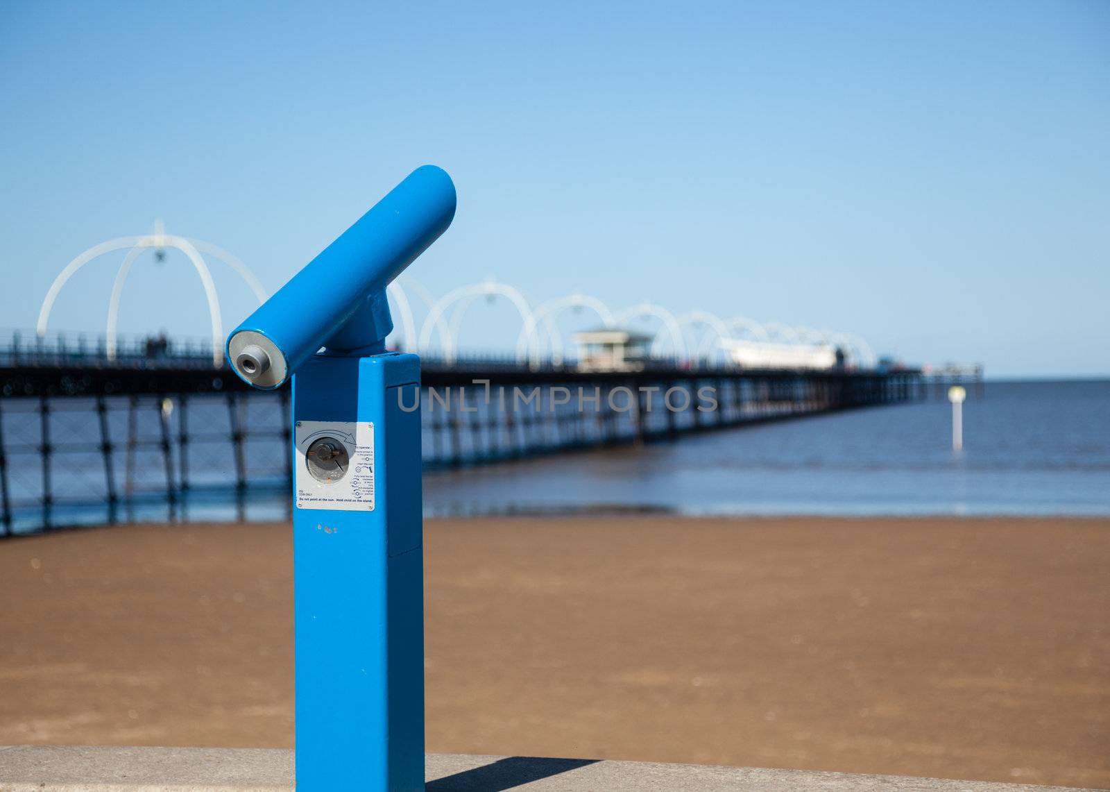 Blue Telescope with sea and pier in Southport England