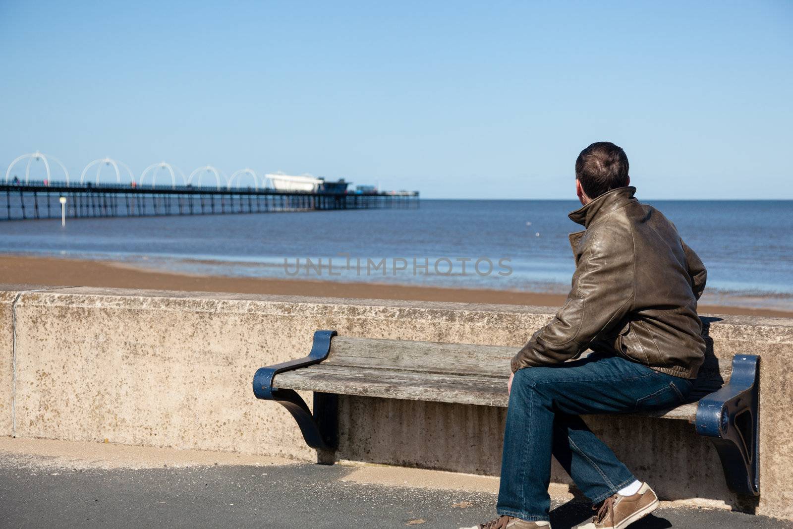 Senior man looking out over beach at Southport by steheap