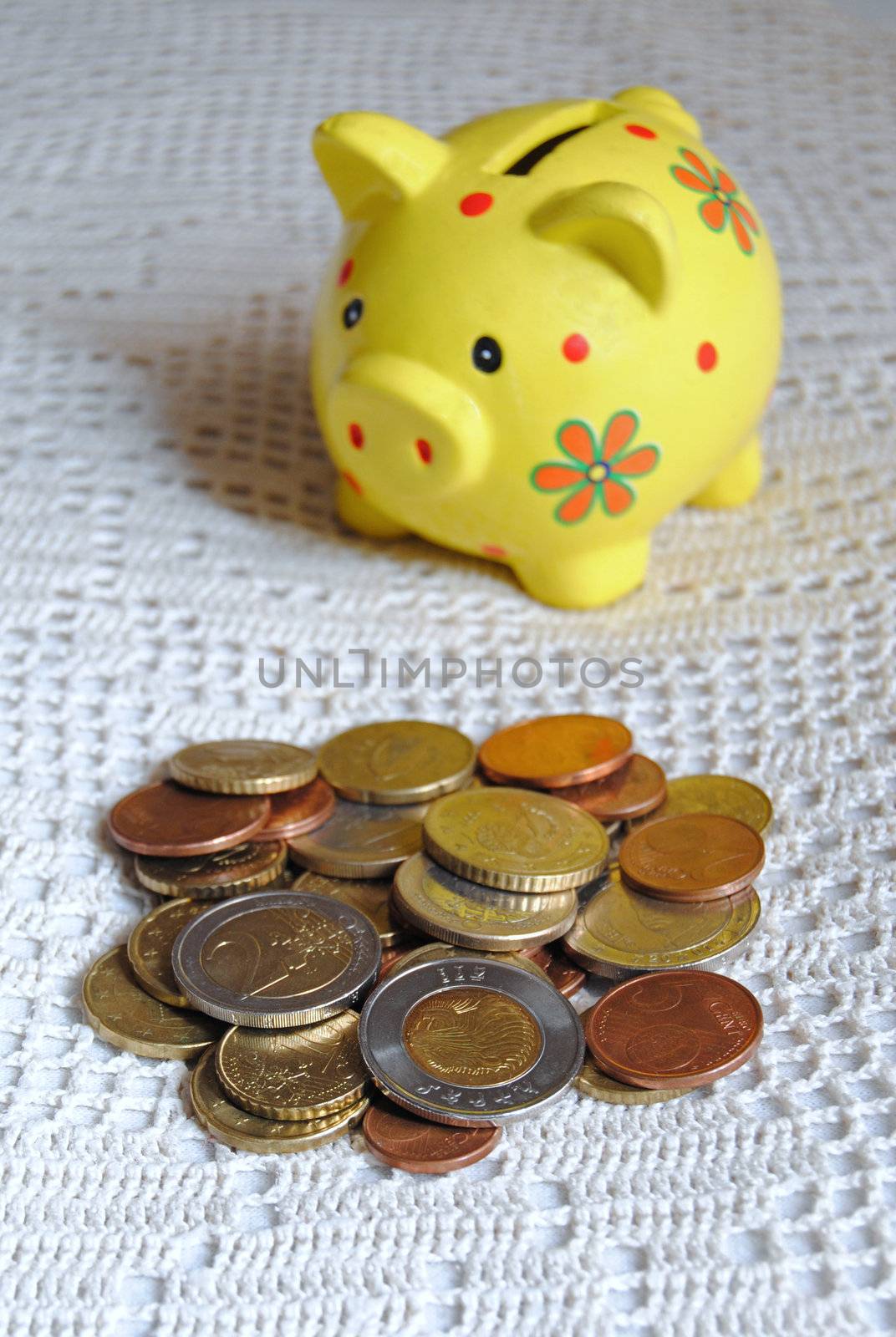 euro coins and yellow piggybank