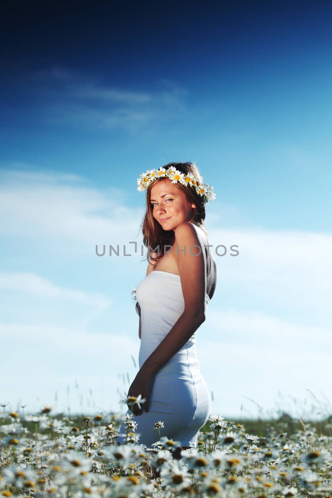 beautiful girl  in dress on the daisy flowers field 