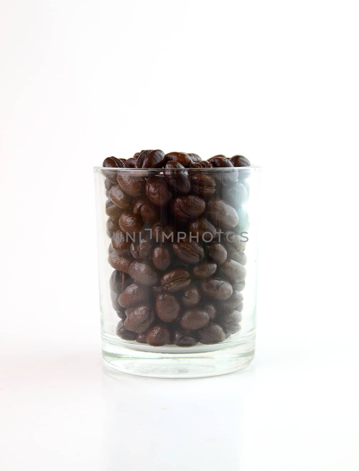 Coffee beans in a small glass on white background