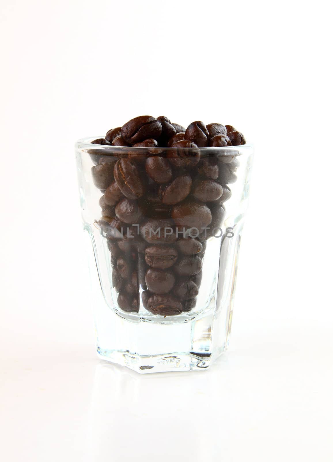Coffee beans in a small glass on white background