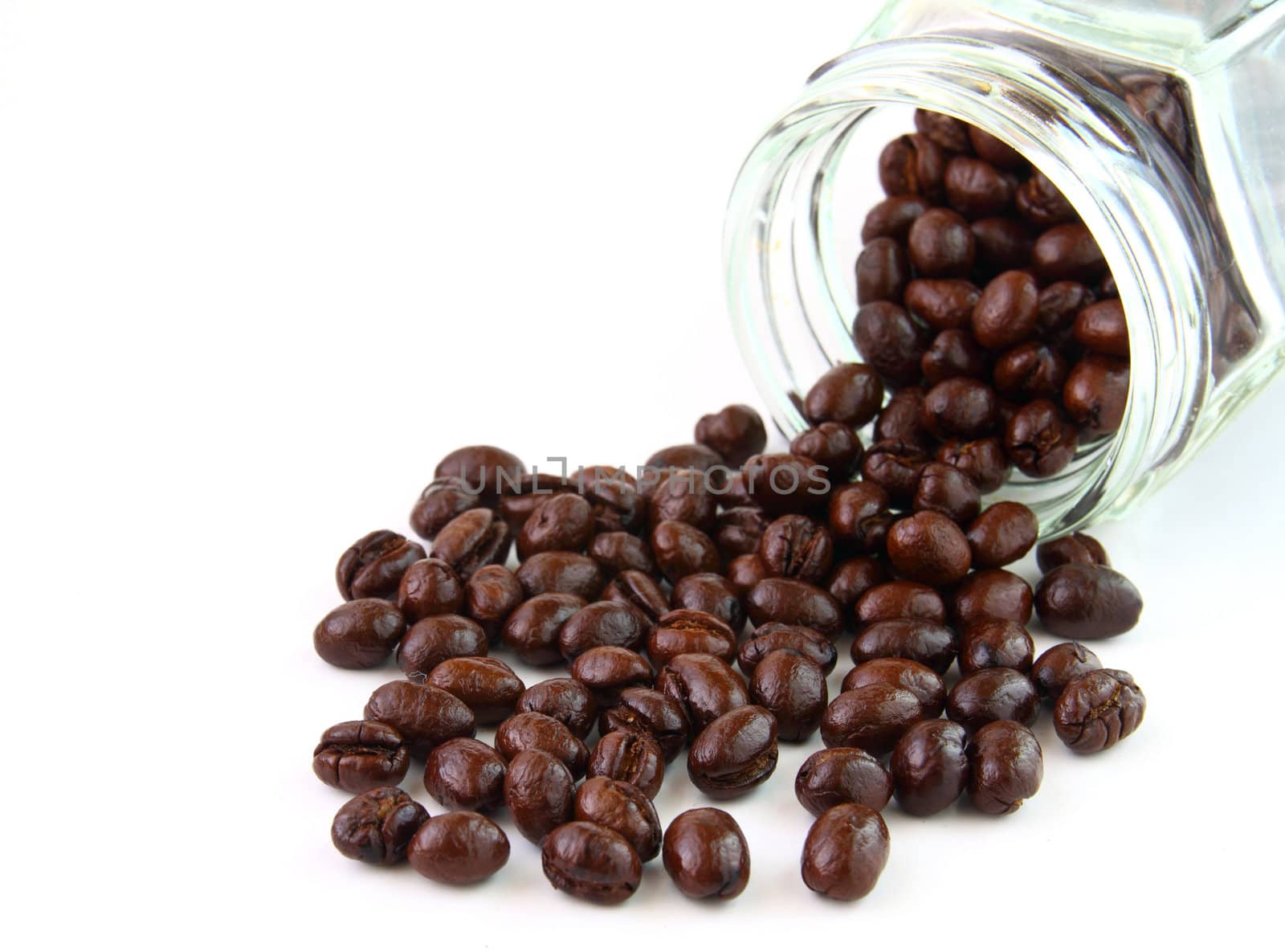 Coffee beans in a glass jar on white background