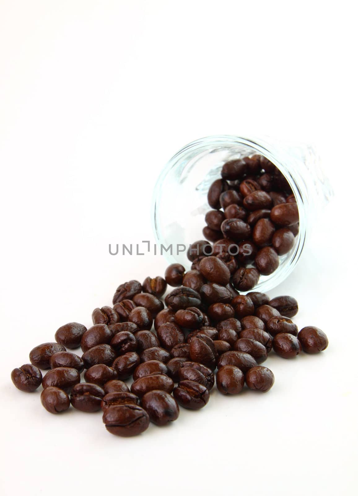 Coffee beans in a glass on white background