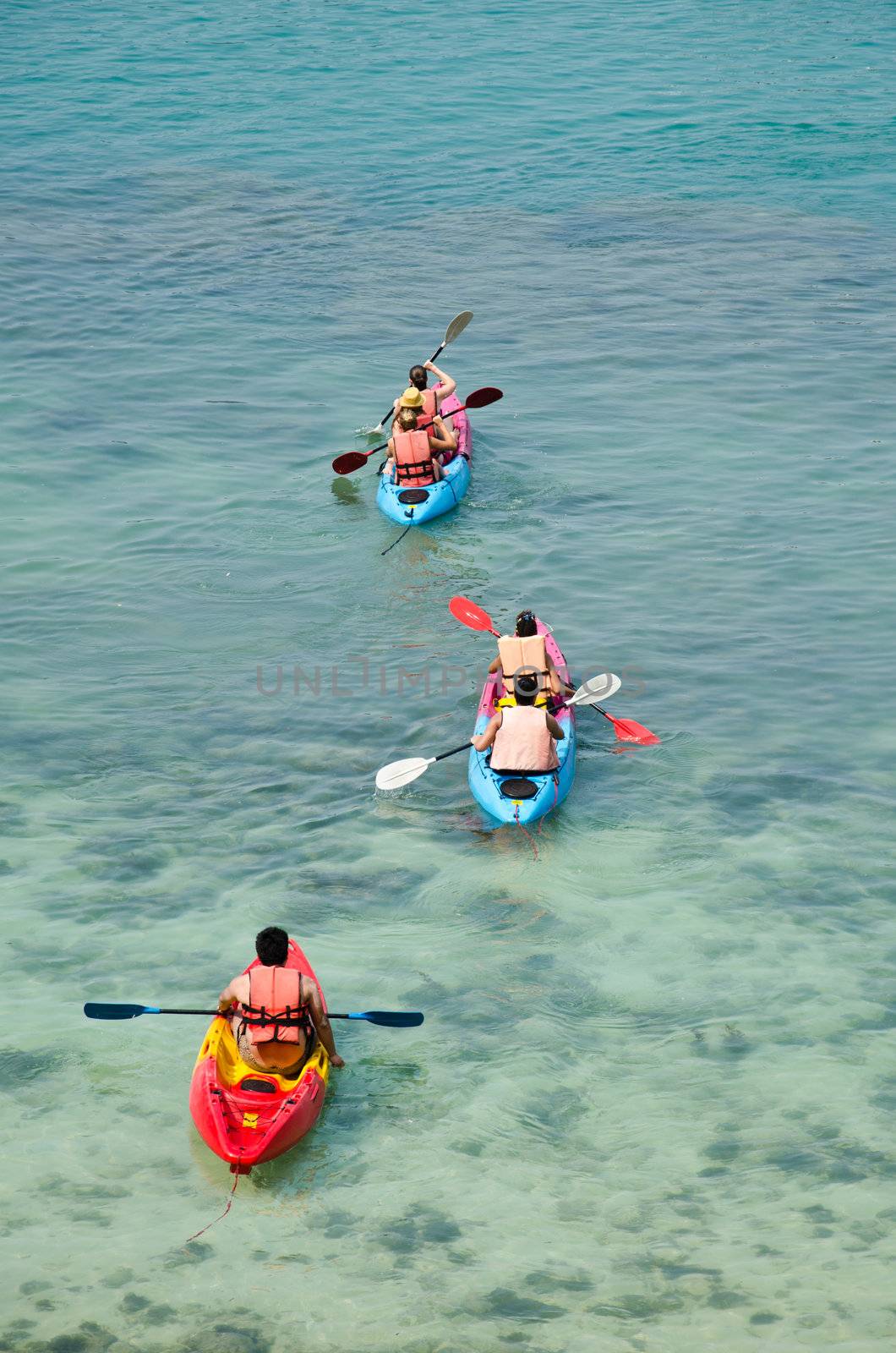 traveler kayaking in the thai ocean from backward view