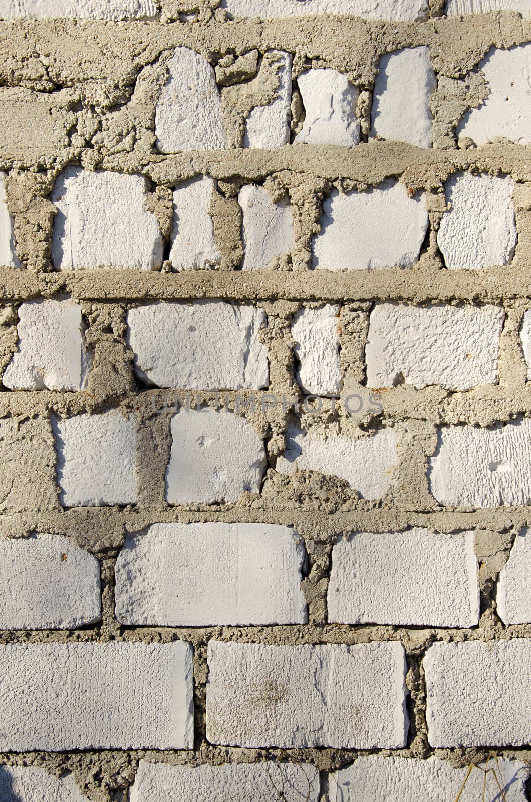 wall made of white brick closeup background. by sauletas