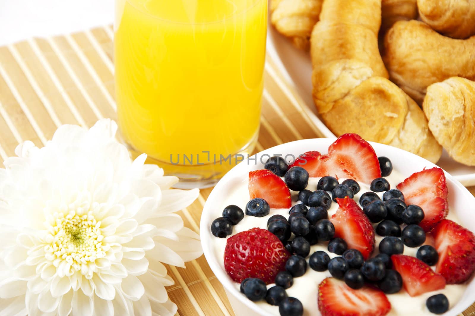 Early breakfast. Strawberries, cream and juice. The symbol of healthy lifestyles.