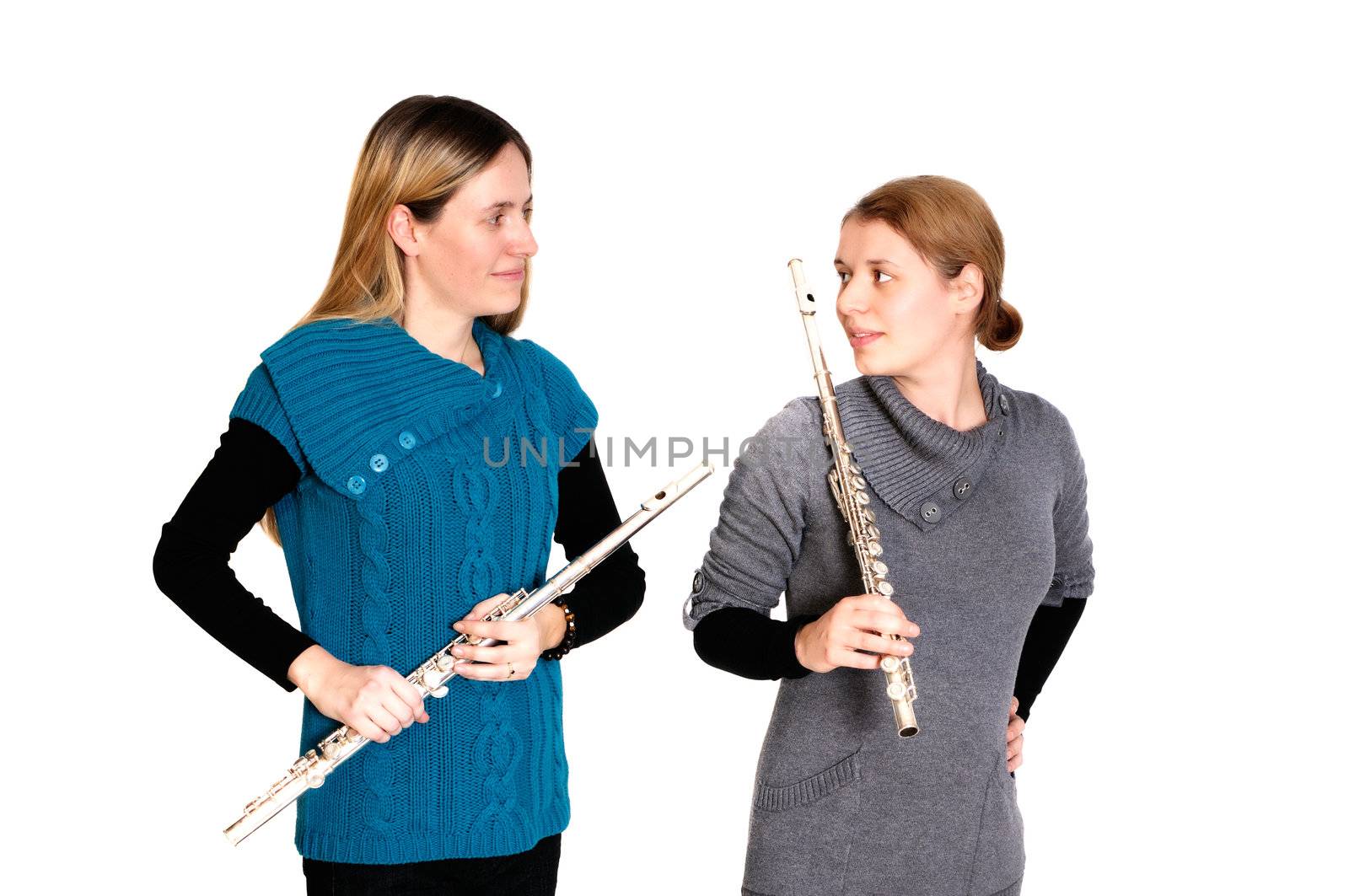Two young women playing transverse flute, isolated on white background.