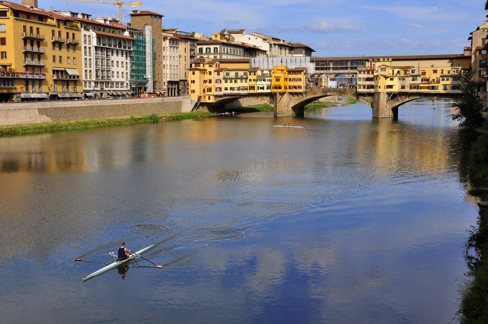 Vecchio Bridge , Florence , Italy, with rower passing by