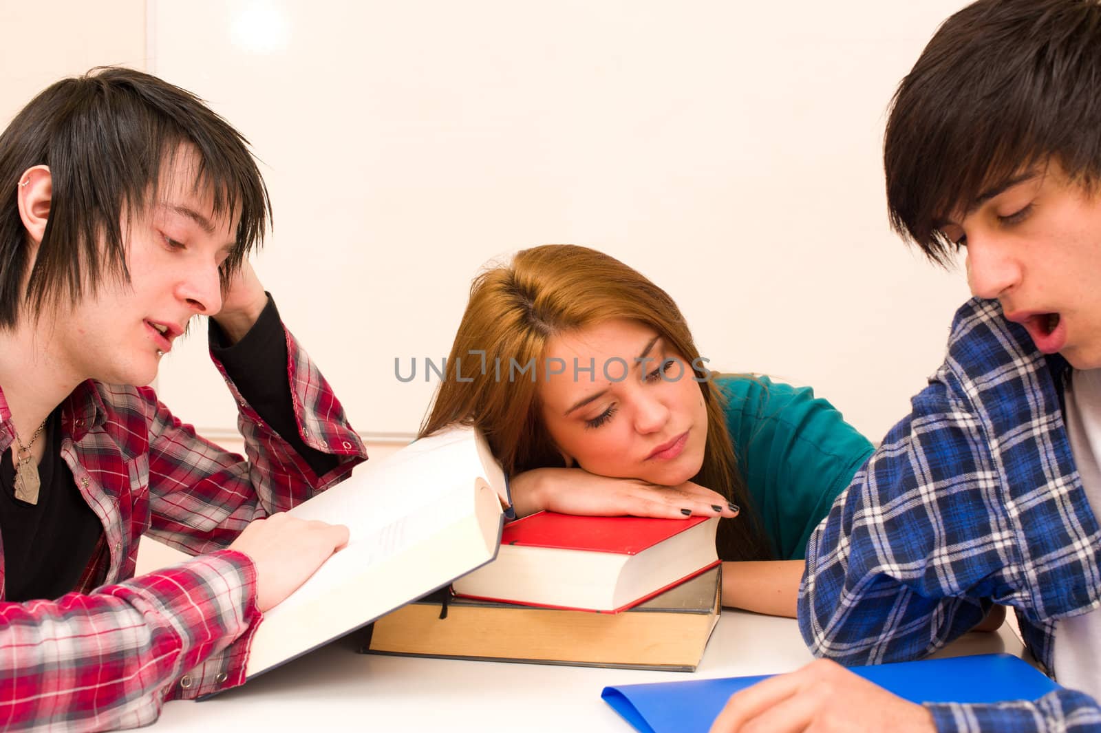 Unmotivated students sitting around their books