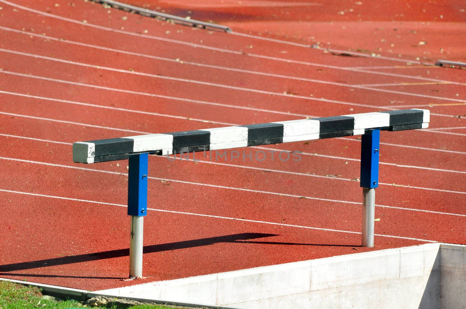 Hurdle in an Athletics Running Track by ruigsantos