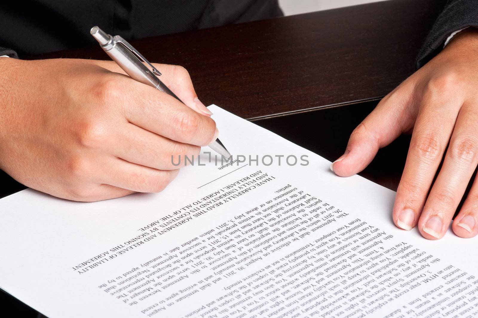 Businesswoman signing a document.