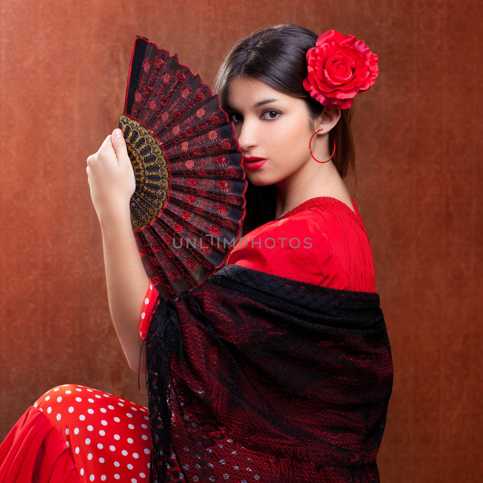 Flamenco dancer Spain woman gipsy with red rose and spanish hand fan