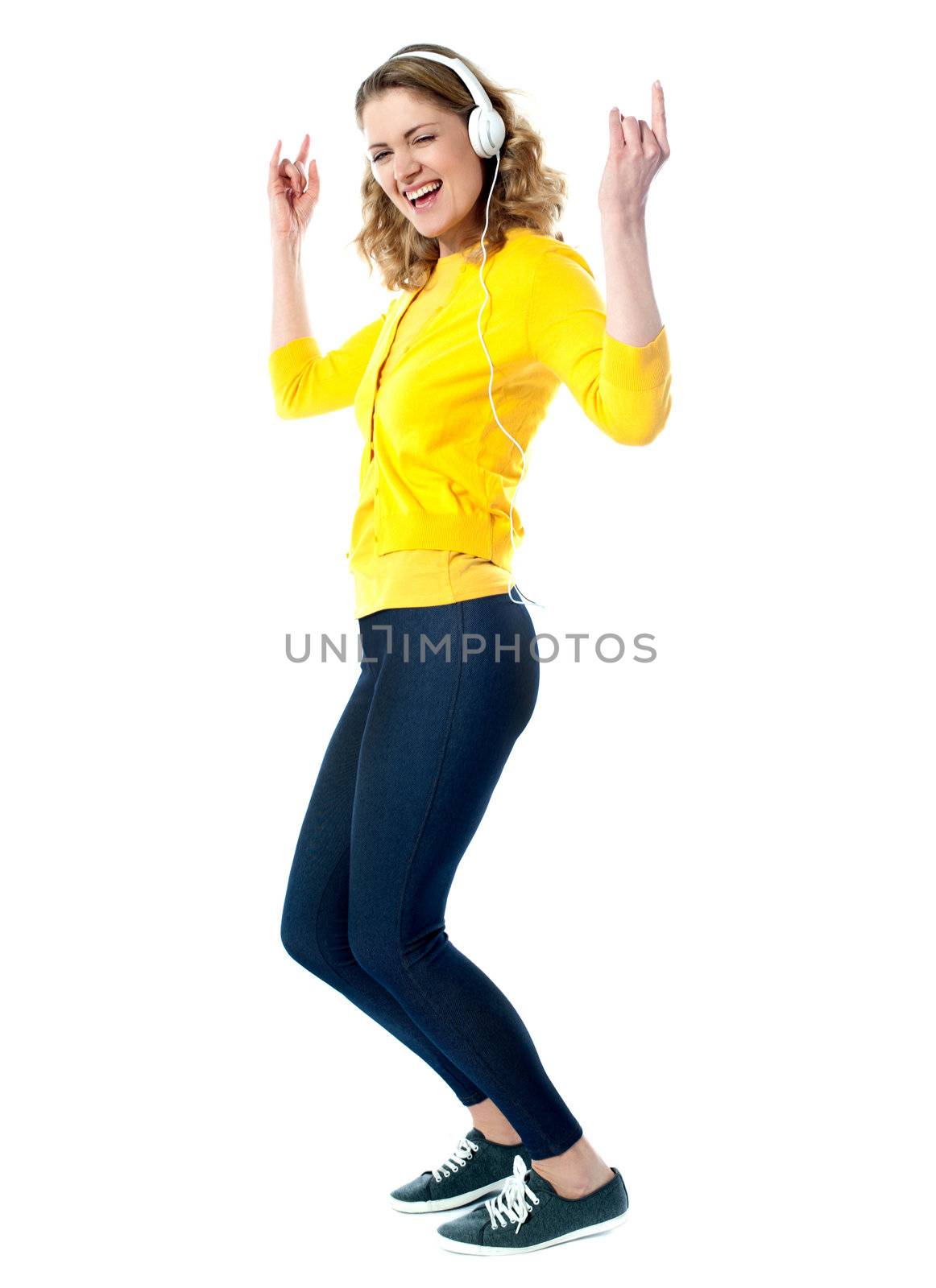 Hip hop woman with headphones enjoying music by stockyimages