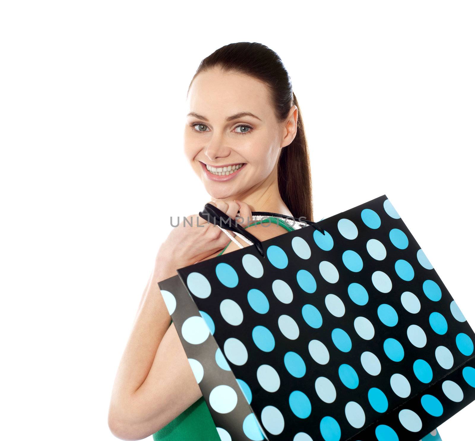 Close-up of happy shopping girl holding bags by stockyimages