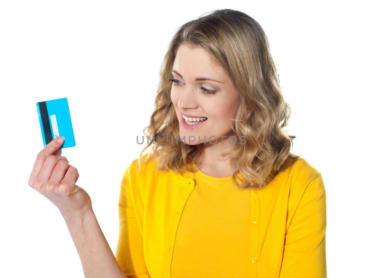 Attractive female holding her credit card by stockyimages